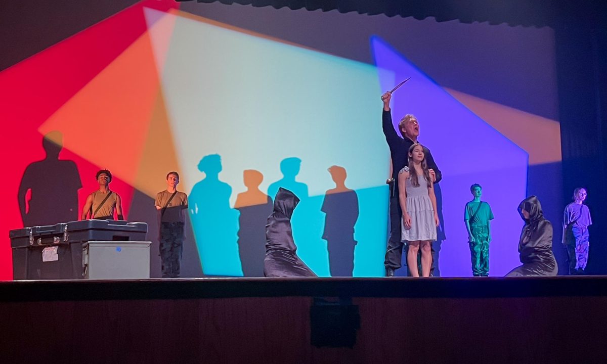 Senior Rowen Hamilton and junior Evie Armour perform an ending scene in the theater departments One Act play Iphigenia at the Founders Day celebration.
