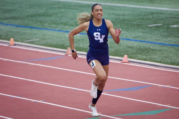 Senior Jazmyn Singh runs down the track during the 400m dash at the region competition April 19.