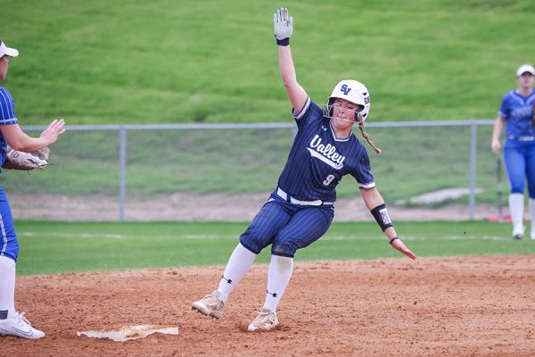 In her approach to third base, sophomore Kamryn Prater prepares to slide to beat the throw out.  