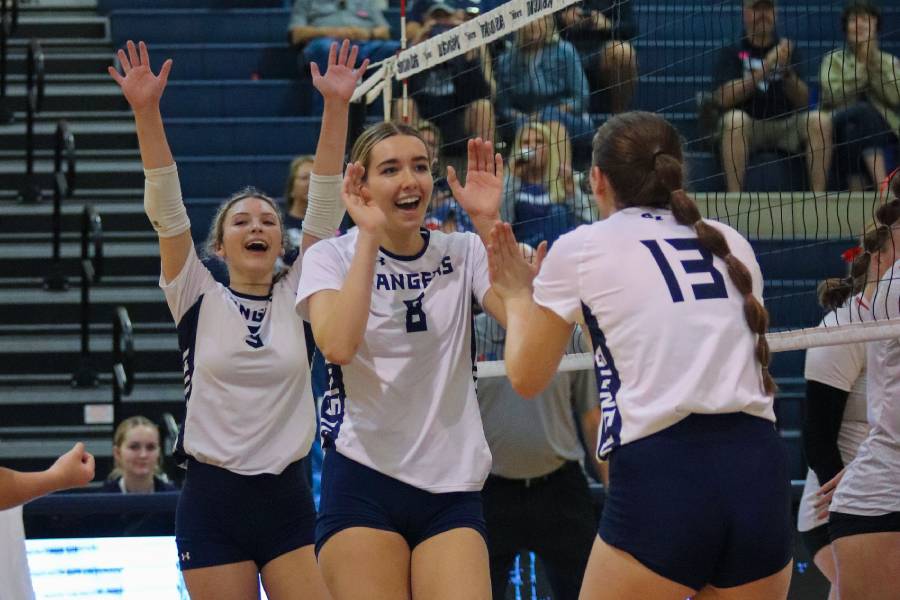 Mckenna Lyles prepares to high five Jacey Owens after a successful kill attempt by the team during Texas Showdown action at the school on Aug. 29.