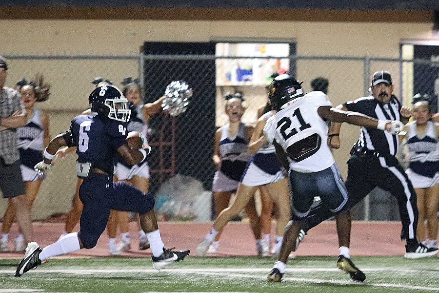 With a defender bearing down on him, junior Quentin Sampson jets down the sideline Sampson had 13 yards rushing Friday against Brennan. 