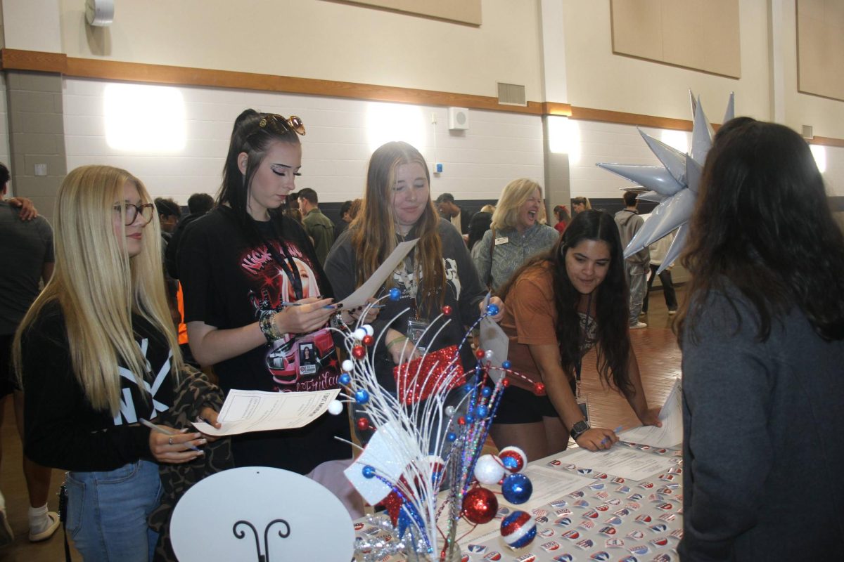 Seniors visit the voter registration table during the Freedom Walk Sept. 24.