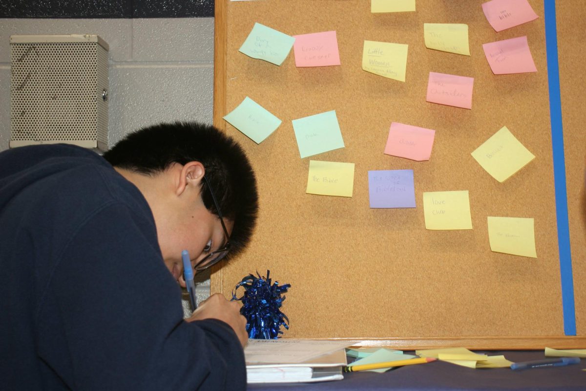 Senior Chris Rodriguez writes his ideas down while visiting the Freedom Walk.