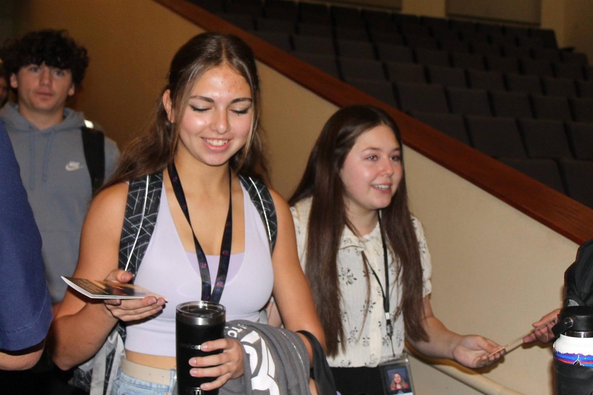 Senior Bridget George holds her pocket sized constitution as she walks into the assembly.