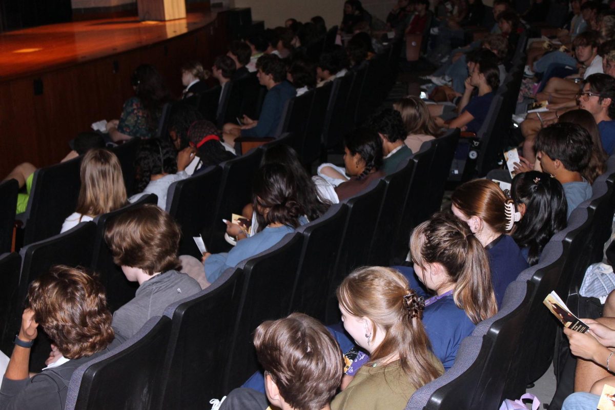 Seniors take part in the Constitution Day assembly by following along in their new pocket constitutions.