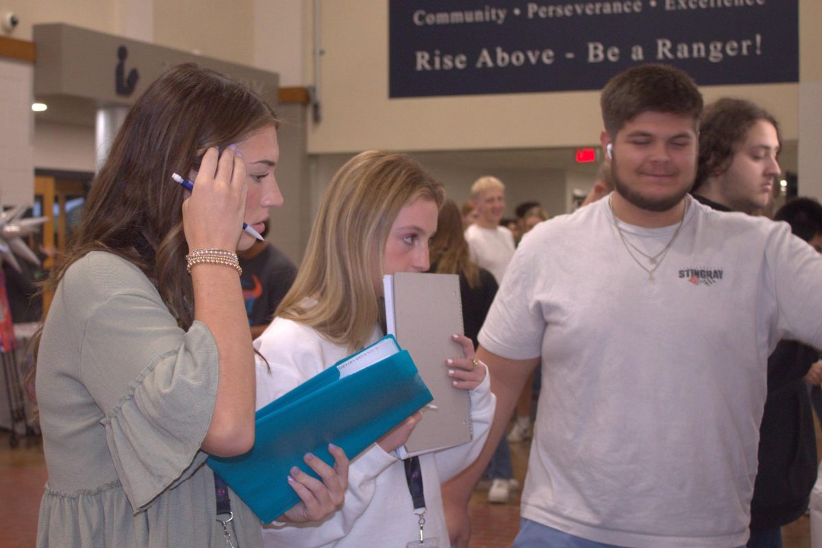 Seniors Reagan Dennis, Mia Castruccio and Gabe Rodriguez take notes at the Freedom Walk.