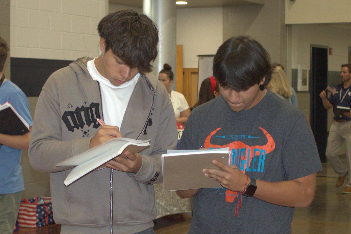 Senior Hector Herrera takes notes during the Freedom Walk on Sept. 24.