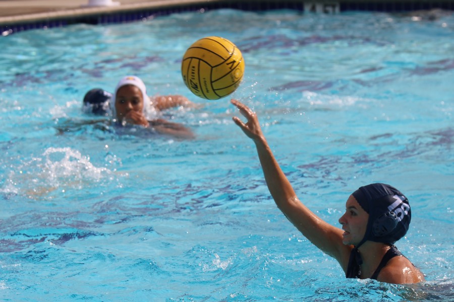 Number 18, junior Bella Edwards looks to make a pass to one of her teammates up ahead.