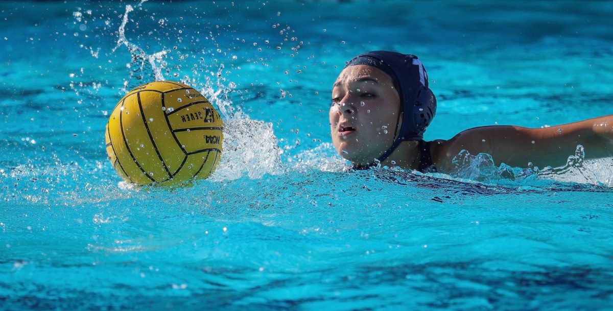 Junior Aubrey Martinez glides through the water to secure the ball. 