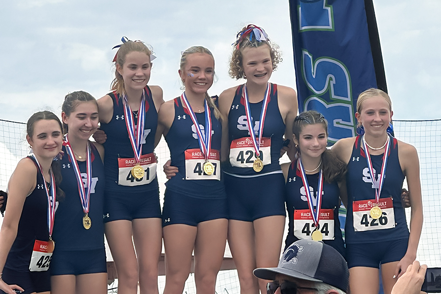 The girls cross country team stands on the podium after winning first place at the UIL Region competition Tuesday. Photo by Bailee Sherrard via Twitter.