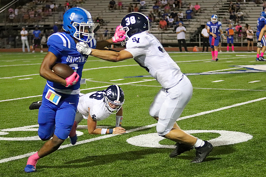 With a faceful of New Braunfels junior Cameron Pitts' glove, sophomore cornerback Hunter Haug puts grabs a handful of jersey during a 29-18 win Friday at Unicorn Stadium. For the season, Haug has had 38 tackles (solo and assisted), two deflected passes, one caused fumble, and three interceptions. Two of those were returned for touchdowns.