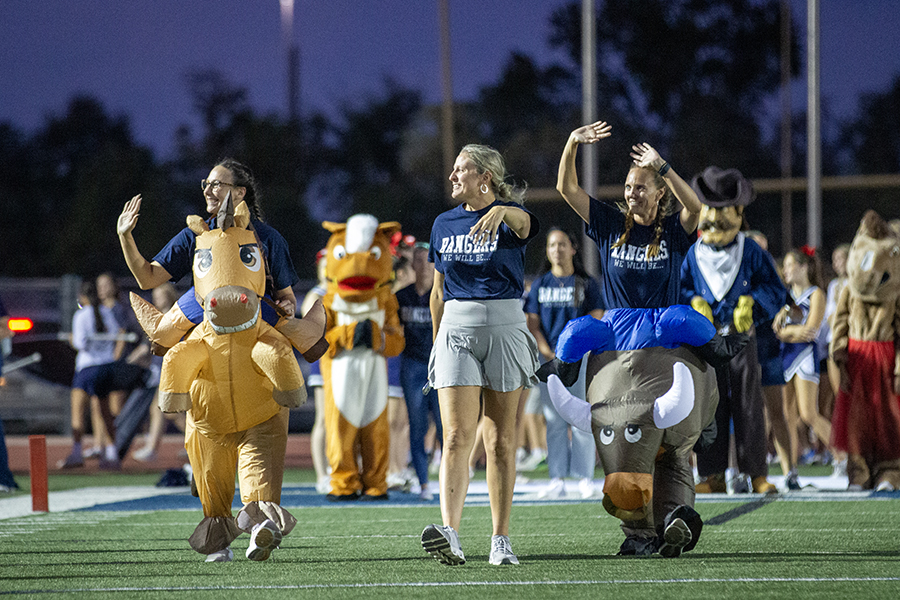 Johnson Ranch Elementary School principal and mascots walk down the field at the beginning of the pep rally.