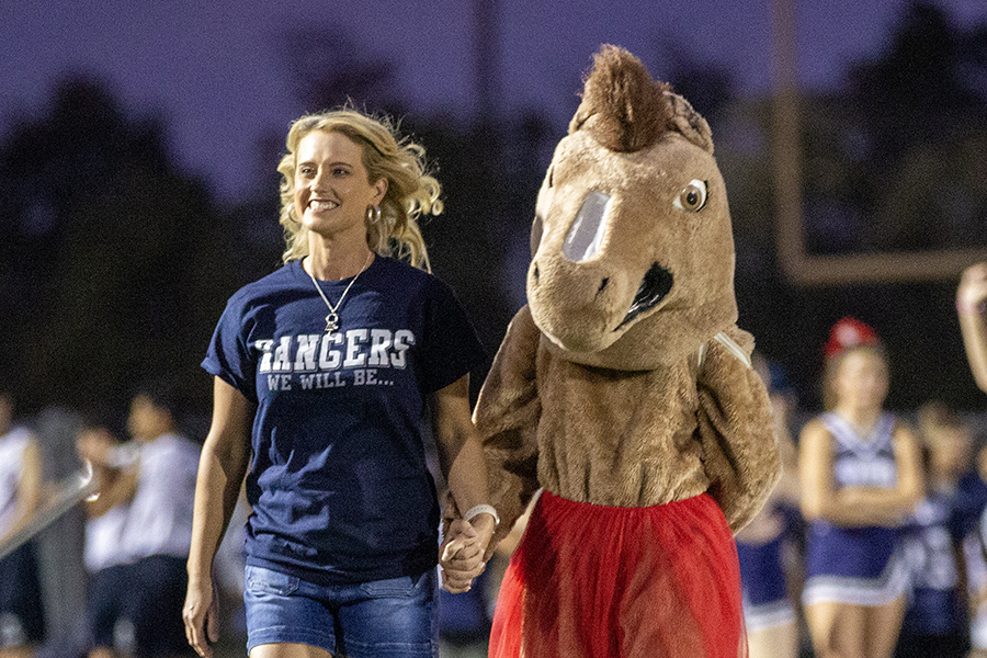 Smithson Valley Middle School principal and mascot strut down the field.