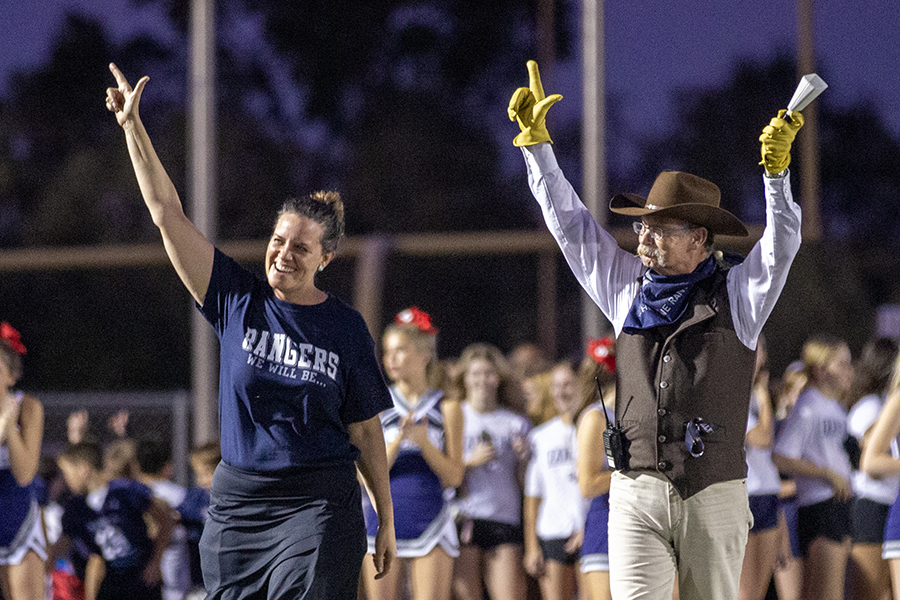 Principal Stacia Snyder and "Ranger" John Bell get their guns up high as the high school's representatives.