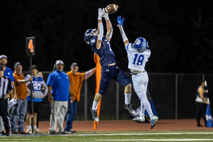 Senior wide receiver Brody Day leaps above his defender to snatch a pass in the end zone, securing a touchdown.