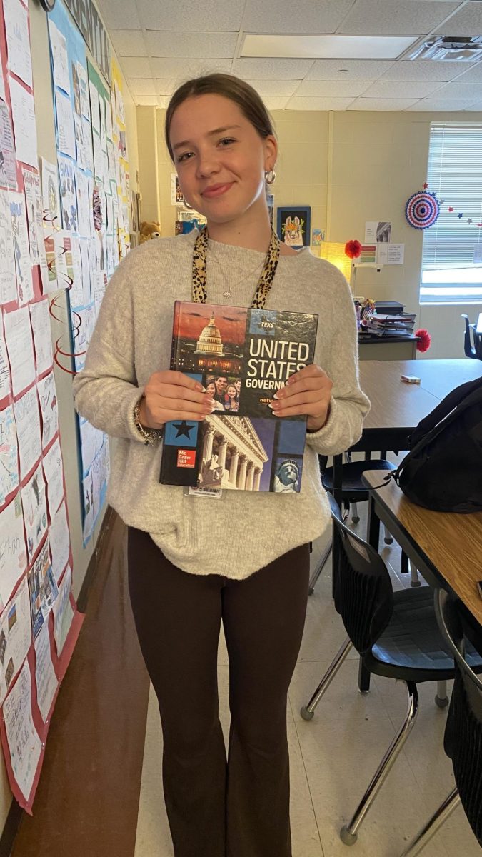 Junior Wiebke Isermann poses with her U.S. government textbook. Isermann is a foreign exchange student from Germany.
