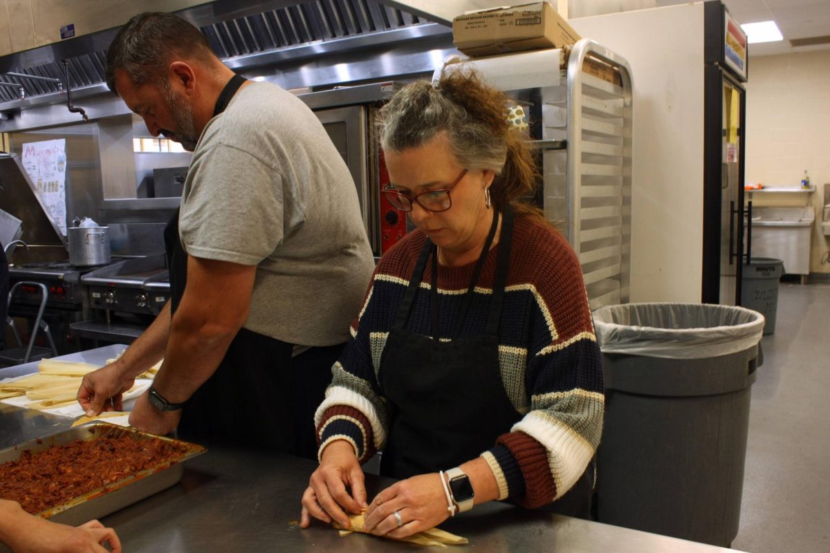 Student support specialist Hope Zettler wraps a tamale while making them with the culinary classes on Tuesday.