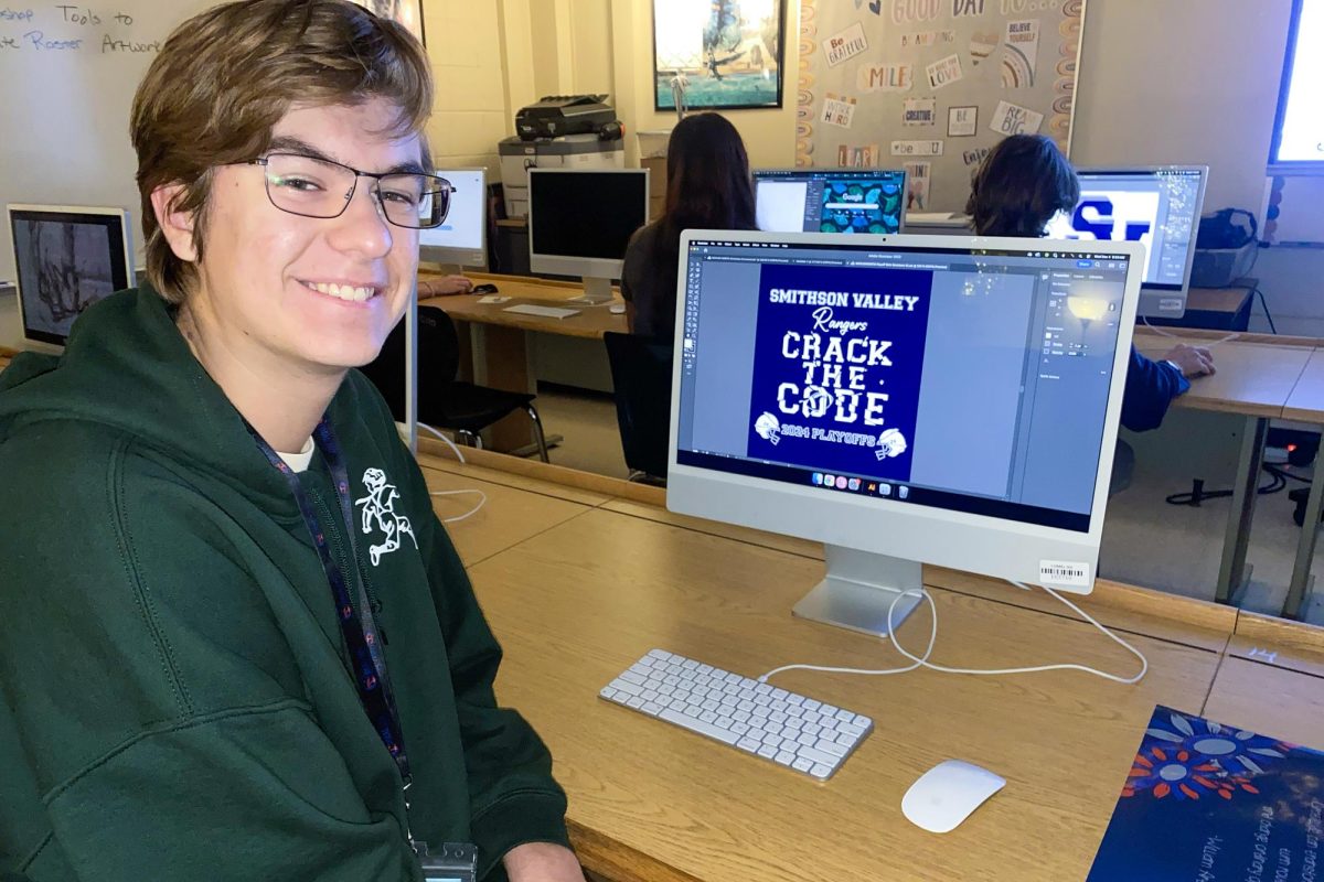 Sophomore Waylon Worth shows off the T-shirt design he created in Nikki Rudloff's graphic design class.