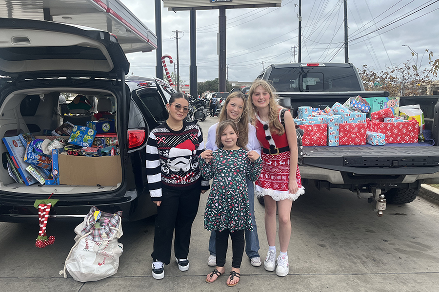 During the toy drive distribution on Dec. 15, Clarissa Wallace, Leah Romero and Adisson Coerver prepare to deliver gifts. (Photo by Jennifer Carrillo)